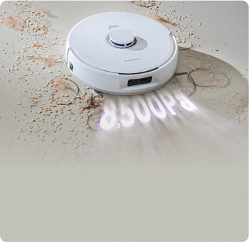 Narwal Freo Pro robot vacuum and mop using 8,500Pa suction to lift dirt, crumbs, and hair from hard floors.