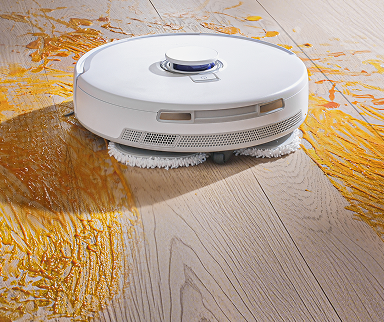 Narwal Freo Pro robot vacuum and mop using high-pressure dual mops to clean sticky spills and tough floor stains.